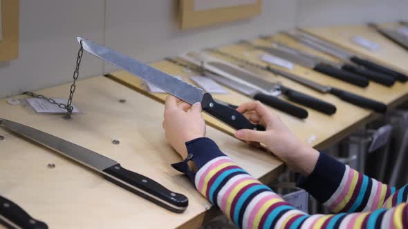 Female Buying New Kitchen Knife in a Store