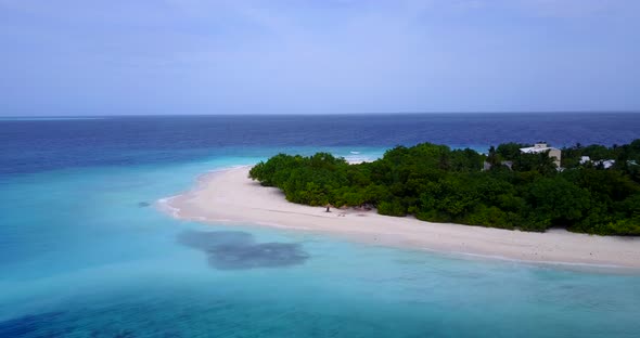 Wide angle fly over island view of a white paradise beach and turquoise sea background in best quali