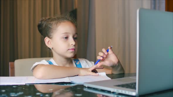 Little Girl a Cute Elementary School Child of 7-8 Years Old at Home Studying in Family Learning