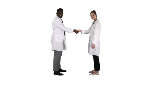 Doctors Shaking Hands and Posing to Camera on White Background