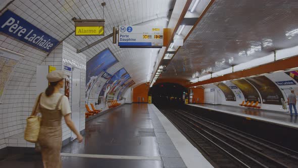 Young girl waiting for a train at station