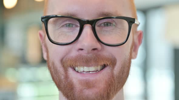 Close Up of Smiling Face of Young Redhead Man 