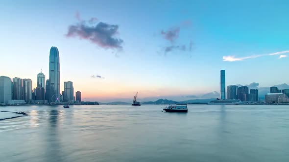Hong Kong China Skyline Panorama with Skyscrapers at Evening From Across Victoria Harbor Timelapse