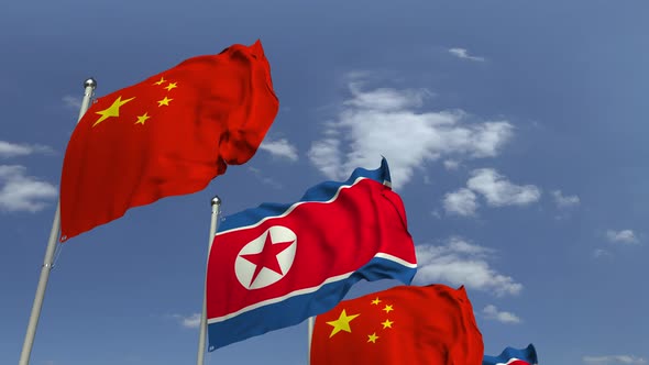 Waving Flags of North Korea and China