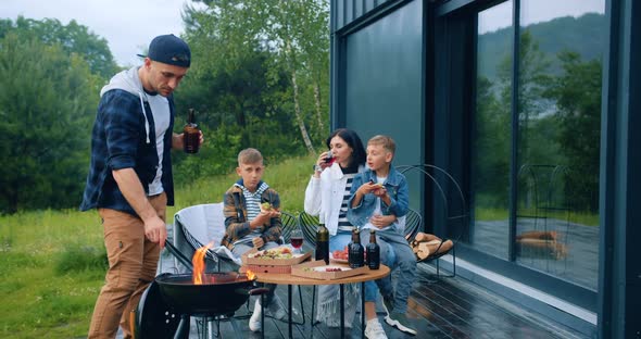 Friendly Family Having Barbecue Together Near their House and Enjoying Joint Leisure