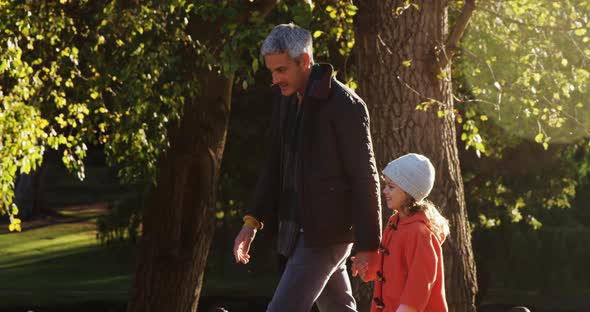 Girl walking with dad outdoors