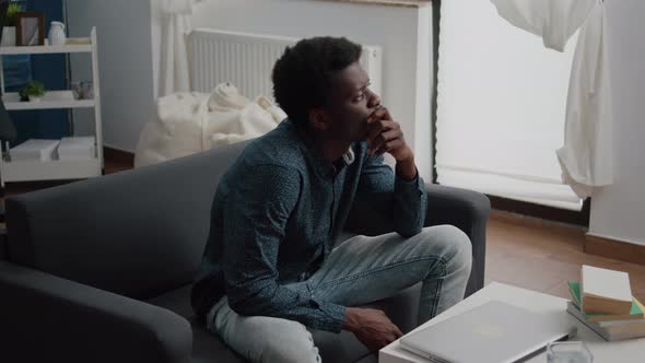 Portrait of Pensive Thoughtful African American Man Looking Out the Window