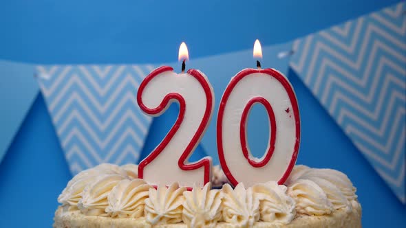 Happy birthday. 20th year, cupcake, birthday cake with candles on a blue background.close-up