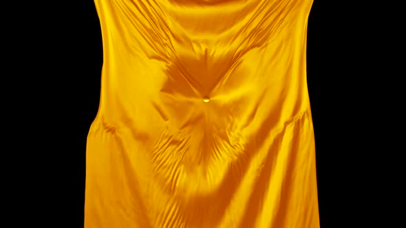 Acrylic ball falling on yellow fabric, Slow Motion