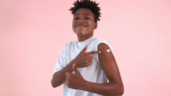 African American Teenager Showing COVID19 Vaccine Bandage Merrily