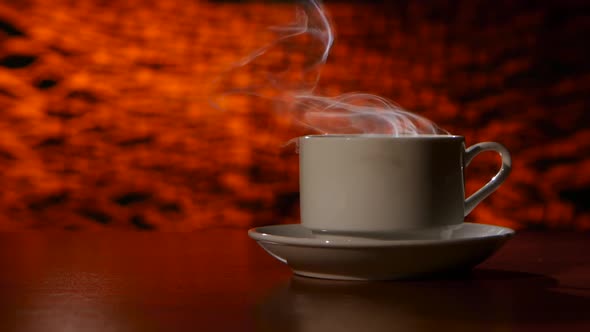 Cup on a White Saucer of Hot Coffee on the Aroma Spreads Room