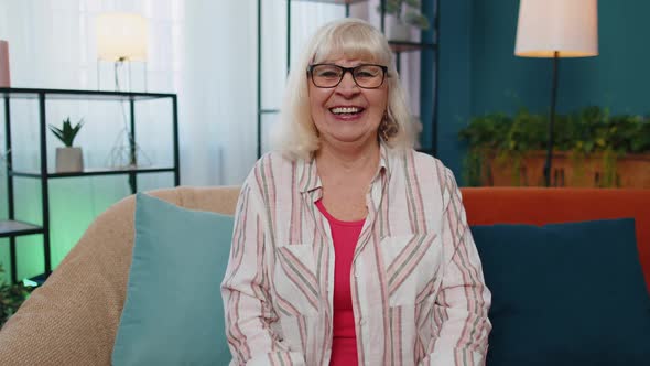 Senior Grandmother Woman Laughing Out Loud After Hearing Ridiculous Anecdote Funny Joke at Home