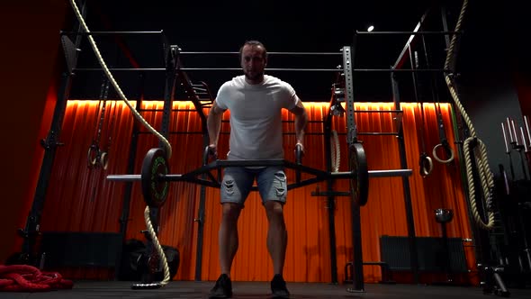 Powerlifter Is Lifting Rod with Weights in Gym, Strongman and Bodybuilder Is Training Alone in