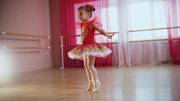 A Little Girl in Red Dress Spins Around Herself