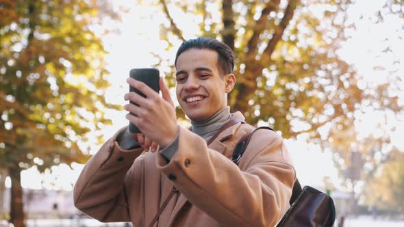 Positive Arabian man talking by phone