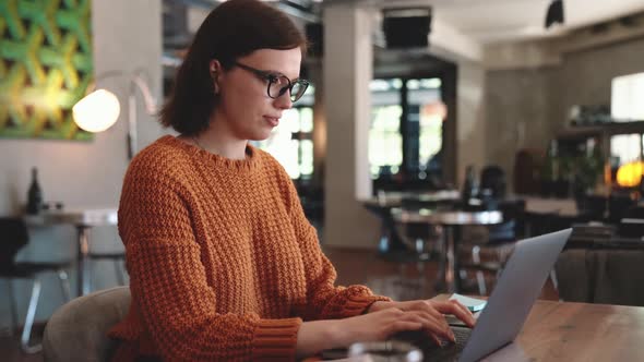 Concentrated red haired woman working