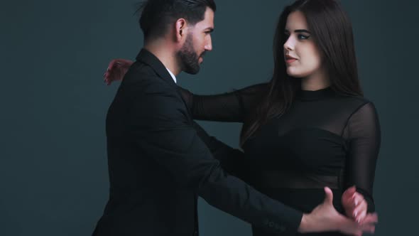 Beautiful Caucasian Longhaired Smiley Woman in Her 20s Dancing with a Bearded Handsome Cuban Guy in