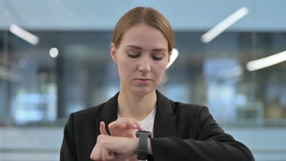 Businesswoman Using Smartwatch for Information