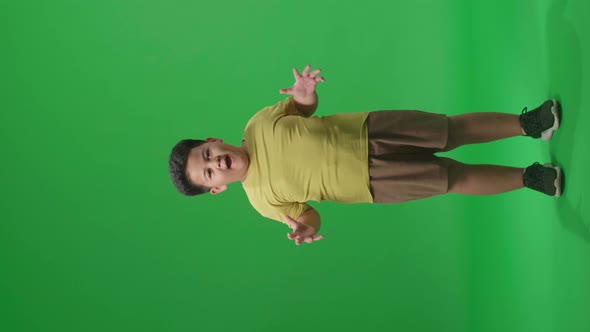 Full Body Of Shocked Asian Little Boy Surprise While Saying Wow On Green Screen Background