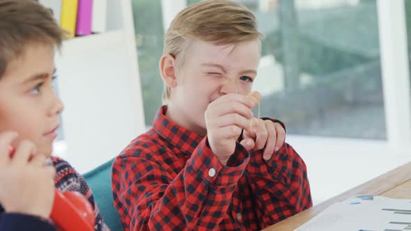 Boy as executive aiming with rubber band