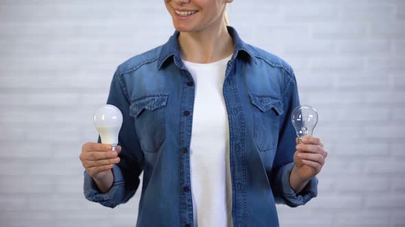 Girl Chooses Energy Saving Led Bulb Instead Incandescent Lamp, Efficiency