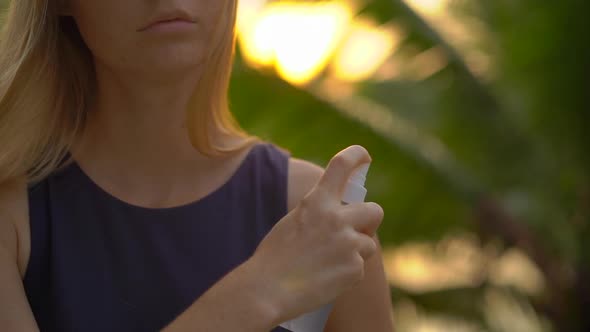 Super Slow Motion Shot of a Beautiful Young Woman Applying an Anti Mosquito Repellent