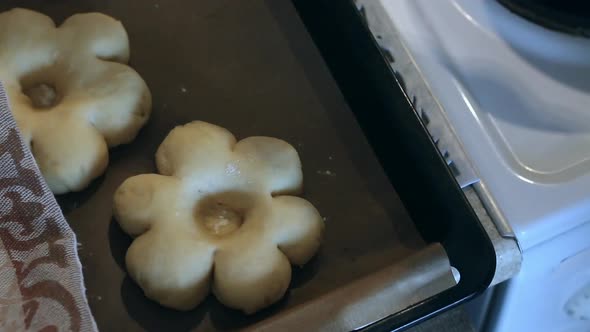 A Woman Covers The Dough Flowers With A Towel. Preparing Donuts In The Form Of A Flower. Close Up.