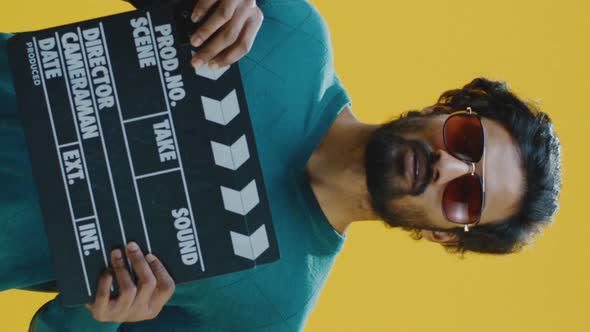 Cheerful Man Clapping Clapperboard