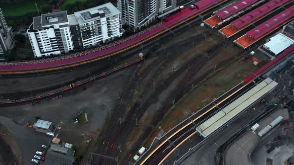 Train Arriving At Roma Street Railway Station In Brisbane CBD, Australia. - aerial slow motion