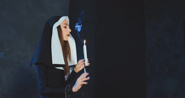 Sexy Nun Lights a Cigarette From Church Candle