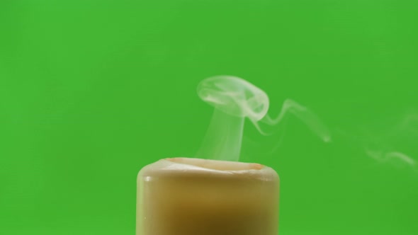 Burning Wax Candle on Green Chroma Key Background