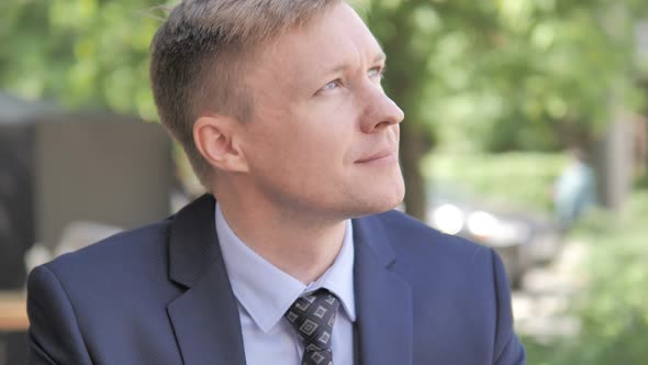 Pensive Businessman Thinking, Sitting Outdoor