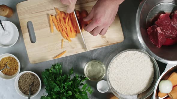 Male Cook Cutting Carrot into Sticks