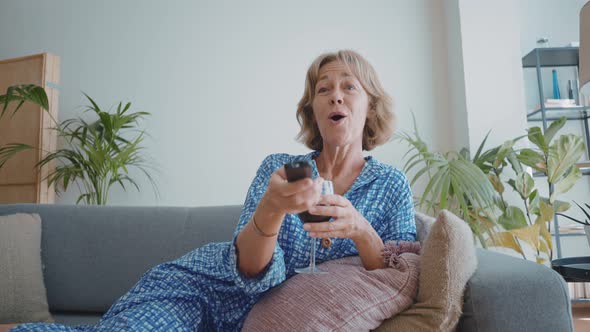 woman enjoying a tv series on the couch