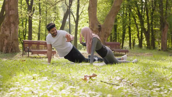 Happy Active Man and Woman Giving High Five to Each Other While Standing in