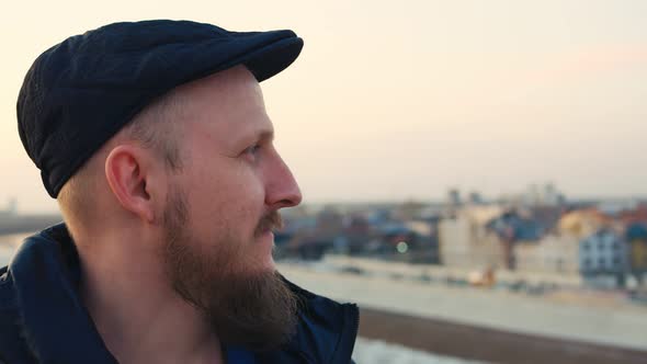 Portrait of a Bearded Man with Blue Eyes in a Cap