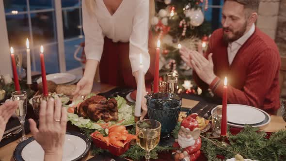 Woman Serves Chicken on the Table on Christmas Eve Everybody Clapping