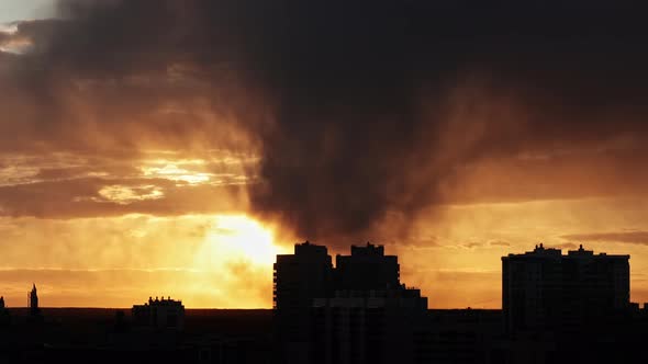 sunset sky against the background of urban buildings and residential buildings, roofs