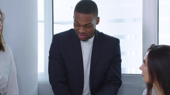 Black Boss Talking to Diverse Staff at Meeting