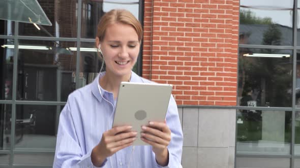 Online Video Chat on Tablet By Walking Woman on Street