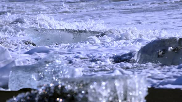 Ice From a Glacier Washing By Atlantic Ocean Waves on a Black Diamond Beach in Iceland. Climate
