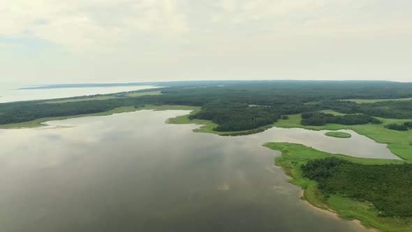 Aerial view of a small lake with stormy sky in Estonia.