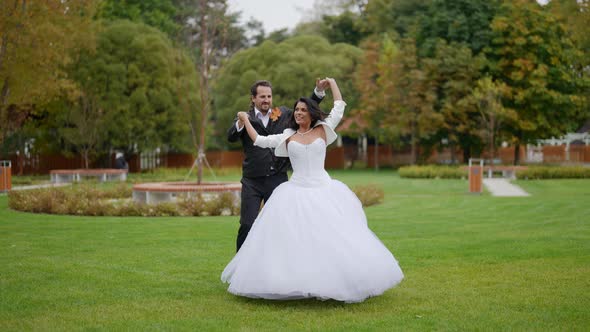 Groom and Bride are Dancing in Park in Wedding Day Happy Bride and Groom