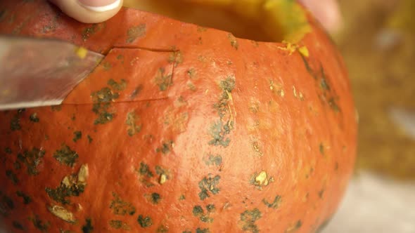 Cutting Out an Eye in a Pumpkin for a Halloween Lantern Decoration Close Up