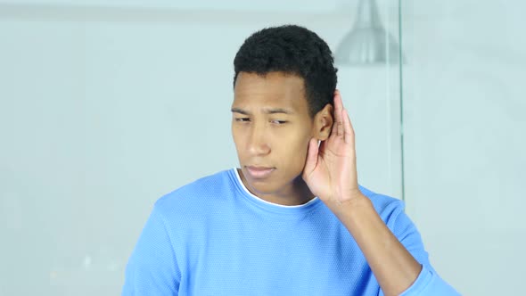 Young Afro-American Man Listening Secret Carefully