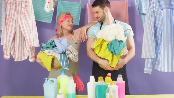 Young Attractive Man and Woman Having Break While Doing Household Chores