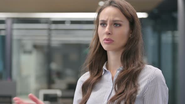 Portrait of Young Businesswoman Checking Watch, Waiting