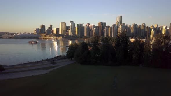 Downtown Skyline Of Coal Harbour Seen From Brockton Point At Stanley Park During Sunrise Surrounded