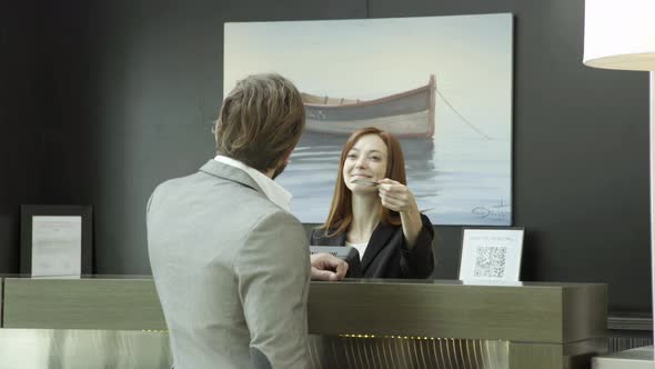 Man using credit card at hotel reception