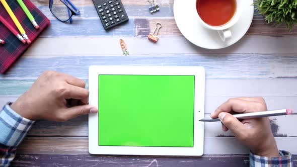 Flat Composition of Young Man Suing Digital Tablet on Office Desk